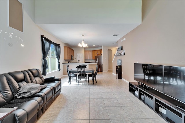 living room featuring light tile patterned floors, sink, and a chandelier