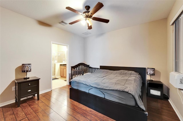 bedroom featuring ceiling fan, dark hardwood / wood-style floors, and ensuite bathroom