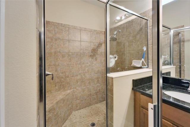 bathroom with an enclosed shower and vanity