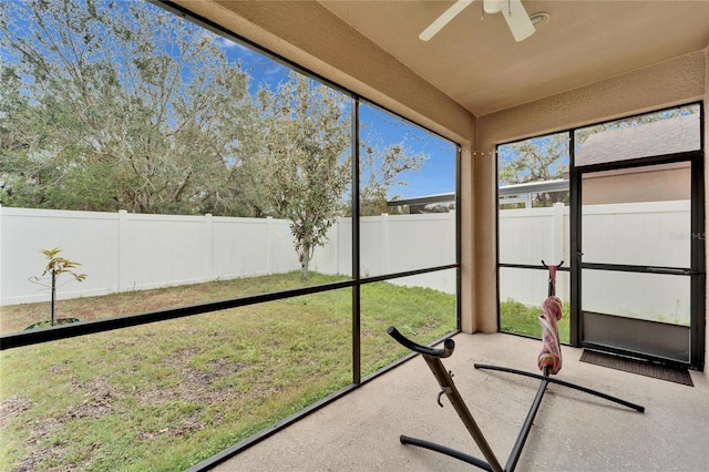 unfurnished sunroom with ceiling fan