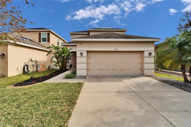 view of front of property featuring a front lawn and a garage