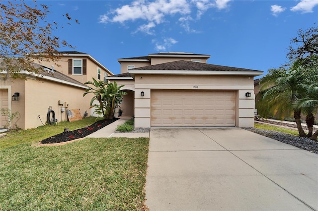 prairie-style home with an attached garage, a front lawn, stucco siding, roof mounted solar panels, and driveway