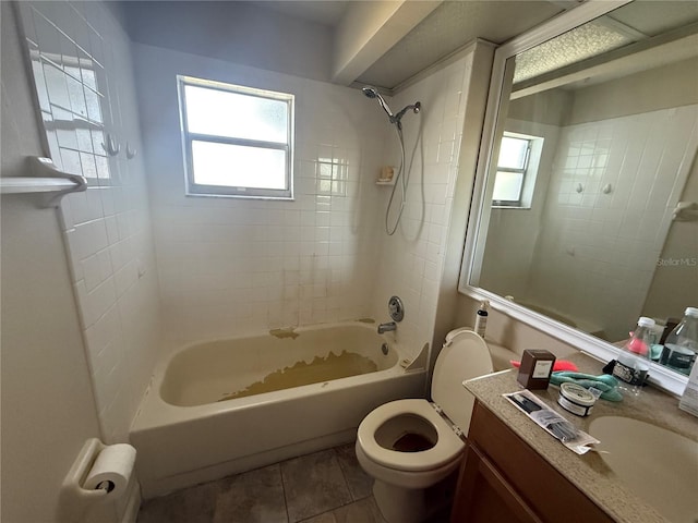 full bathroom featuring toilet, tiled shower / bath, tile patterned flooring, and vanity