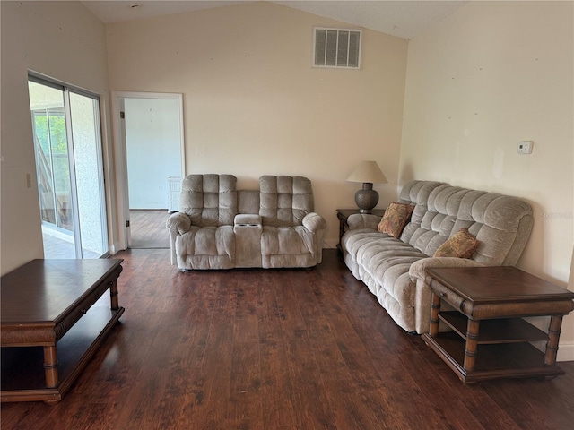 living area with wood finished floors and lofted ceiling