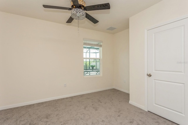 spare room featuring ceiling fan and light colored carpet