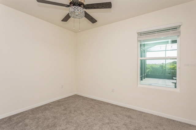 carpeted empty room featuring ceiling fan