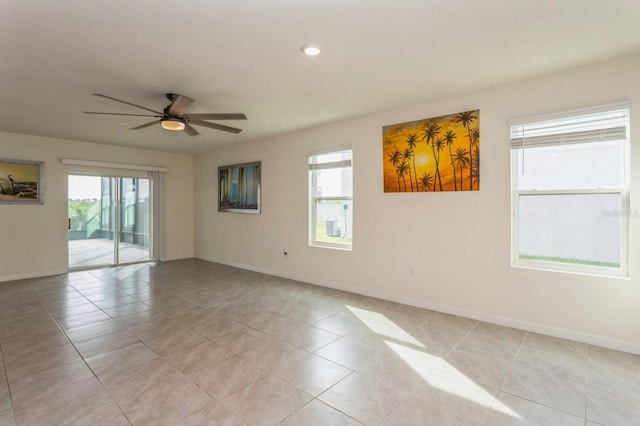 tiled empty room featuring ceiling fan