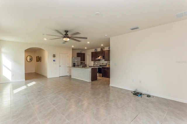 interior space with light tile patterned flooring and ceiling fan