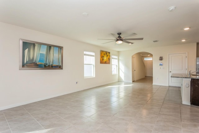 spare room with light tile patterned floors and ceiling fan