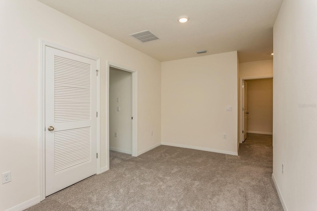 spare room with light colored carpet