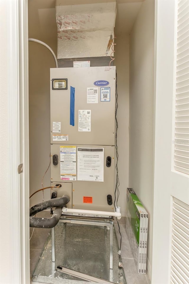 utility room featuring heating unit