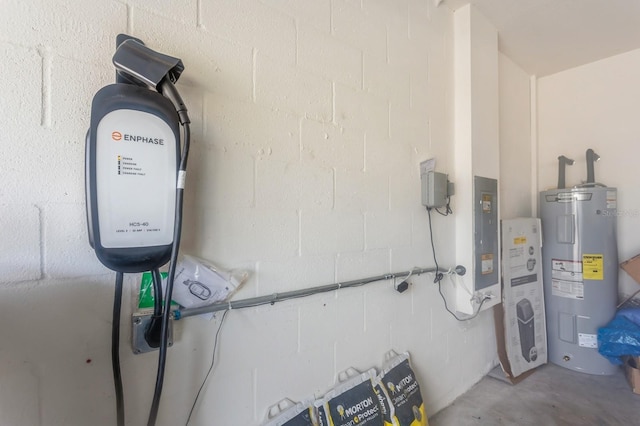 utility room featuring electric panel and electric water heater