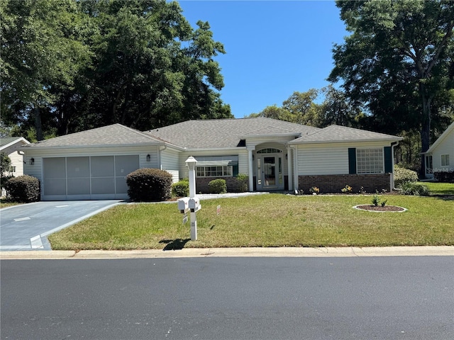 14544 SW 112th Cir, Dunnellon, FL 34432 - ranch-style home featuring concrete driveway, an attached garage, a front lawn, brick siding, and a shingled roof