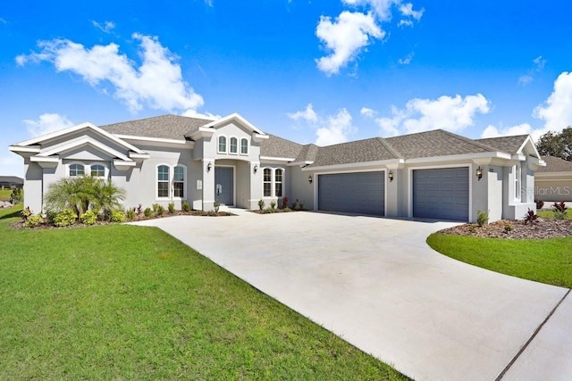 view of front facade with a garage, driveway, and a front lawn