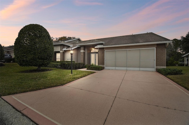 view of front of home featuring a garage and a lawn