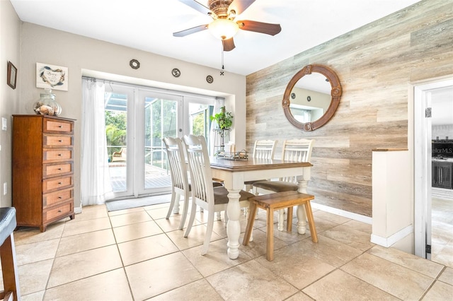 tiled dining space with ceiling fan and french doors