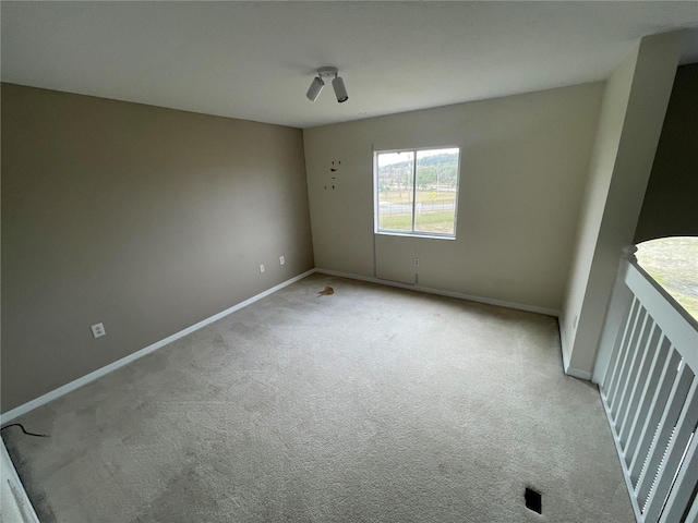 empty room with light colored carpet