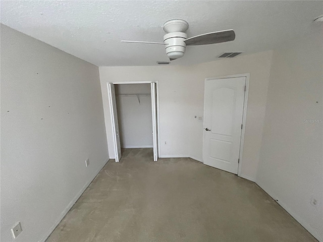 unfurnished bedroom featuring a textured ceiling, ceiling fan, a closet, and light colored carpet