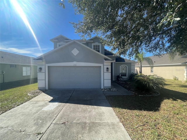 view of property with a front yard and a garage