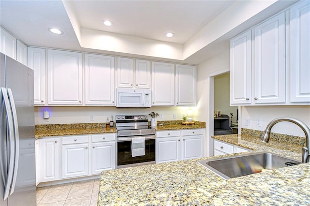 kitchen featuring sink, white cabinetry, light tile patterned floors, light stone countertops, and stainless steel appliances