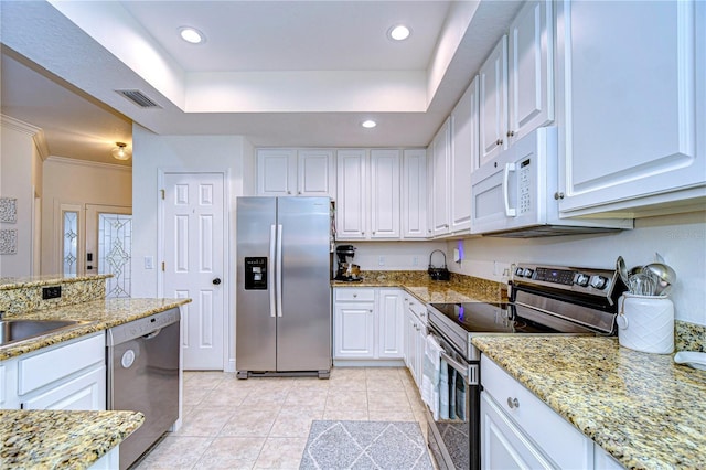 kitchen featuring white cabinets, light stone counters, and appliances with stainless steel finishes