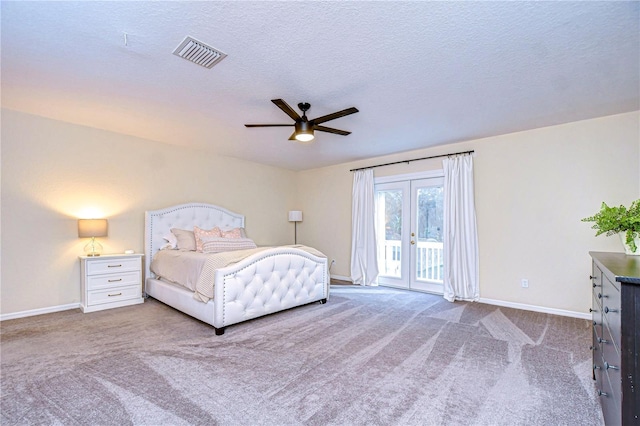 unfurnished bedroom featuring a textured ceiling, light colored carpet, access to exterior, and ceiling fan