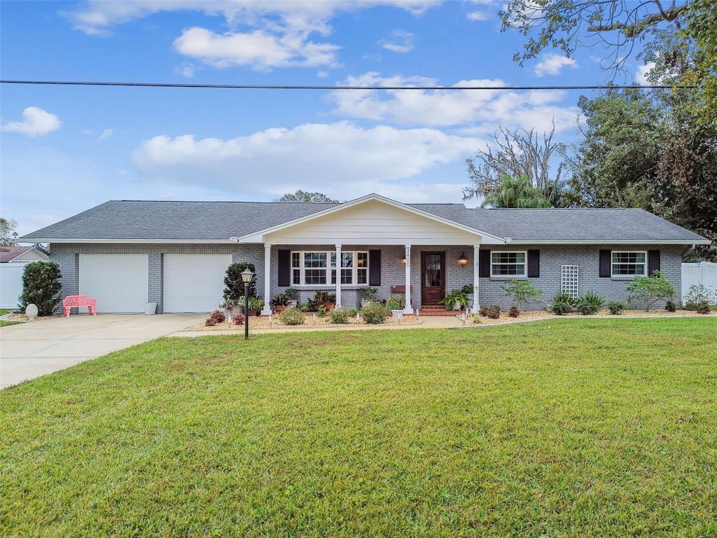 single story home featuring a front yard and a garage