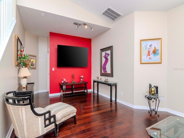 living area featuring dark hardwood / wood-style flooring and vaulted ceiling