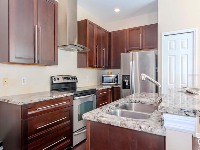 kitchen with wall chimney exhaust hood, stainless steel appliances, sink, and light stone counters