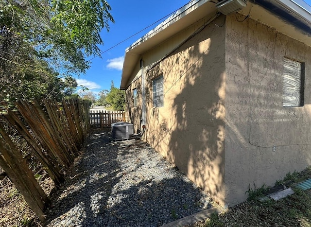 view of side of home featuring central AC