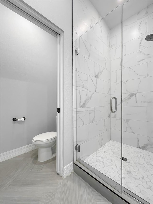 bathroom featuring toilet, walk in shower, and tile patterned flooring