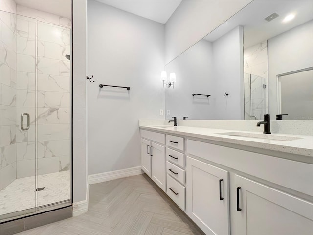 bathroom with parquet flooring, an enclosed shower, and vanity