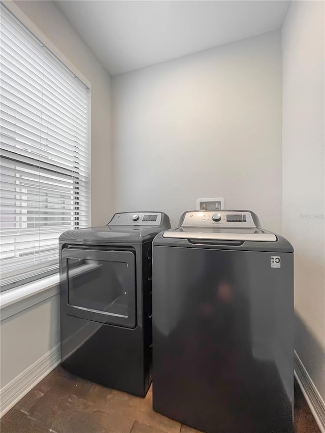 clothes washing area with washer and clothes dryer