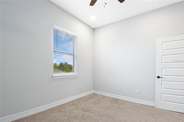 spare room featuring ceiling fan and light colored carpet