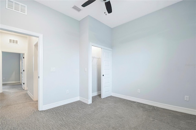 unfurnished bedroom with light colored carpet, a closet, and ceiling fan