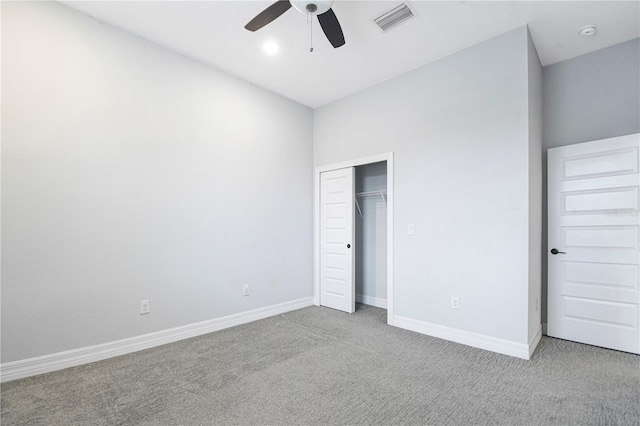 unfurnished bedroom with a closet, ceiling fan, and light carpet