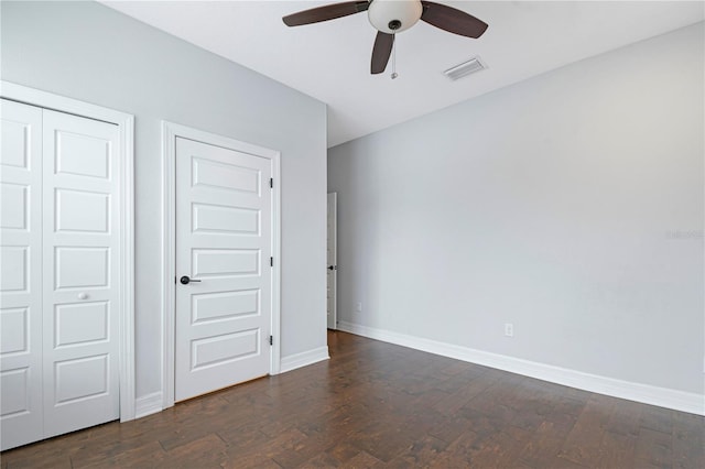 unfurnished bedroom featuring ceiling fan and dark hardwood / wood-style flooring