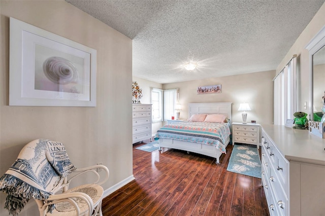 bedroom with dark hardwood / wood-style flooring and a textured ceiling