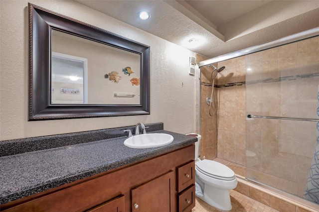 bathroom featuring a textured ceiling, tile patterned flooring, vanity, toilet, and tiled shower