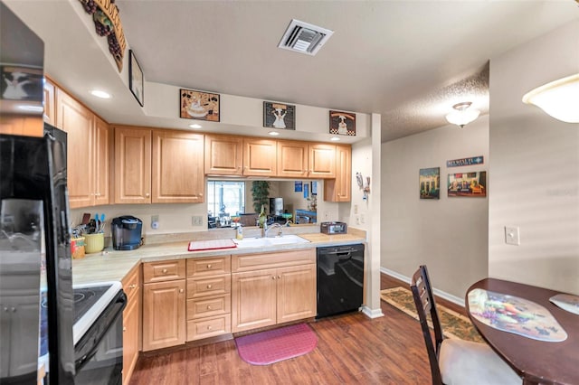 kitchen featuring black appliances, sink, dark wood-type flooring, a textured ceiling, and light brown cabinetry