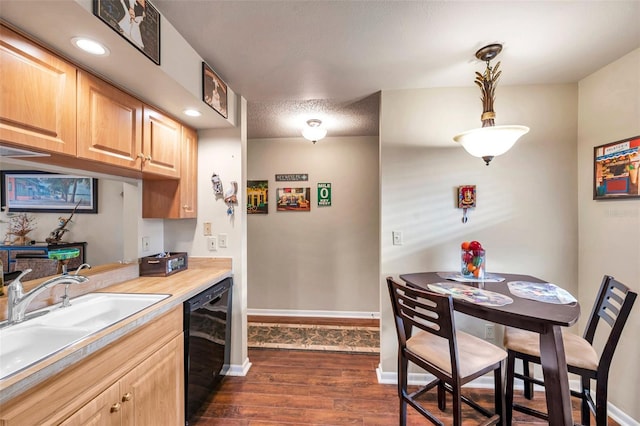 kitchen featuring dark wood-type flooring, black dishwasher, light brown cabinetry, and sink