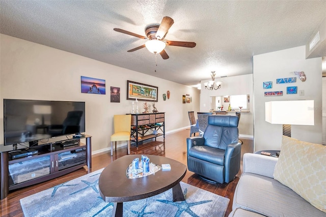 living room featuring wood-type flooring, a textured ceiling, and ceiling fan with notable chandelier