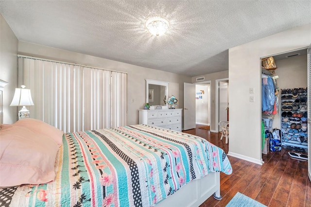 bedroom featuring dark hardwood / wood-style floors and a textured ceiling