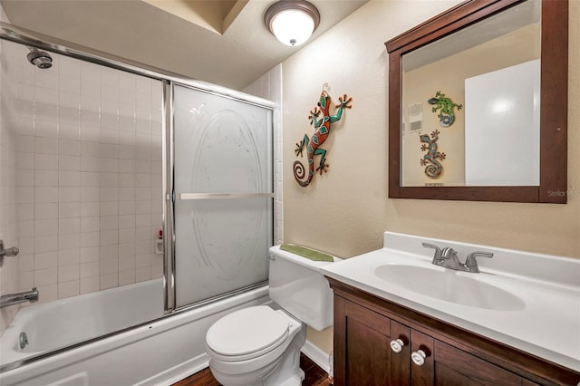 full bathroom featuring enclosed tub / shower combo, toilet, vanity, and hardwood / wood-style floors