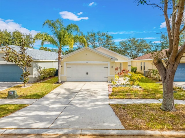 ranch-style home featuring a garage and a front lawn