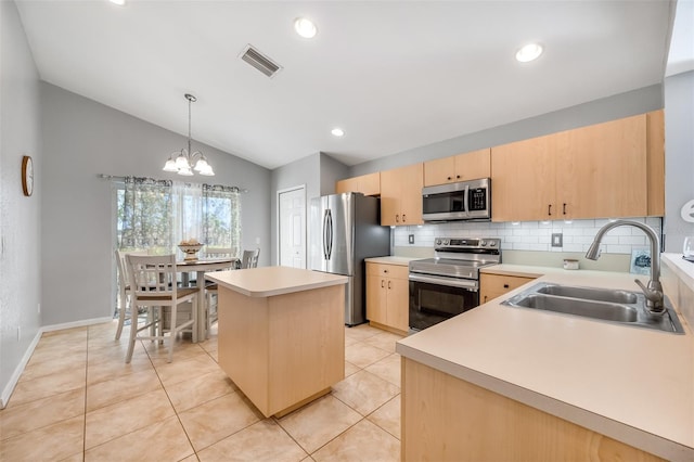 kitchen with lofted ceiling, a kitchen island, light brown cabinets, stainless steel appliances, and sink