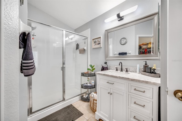 bathroom with lofted ceiling, vanity, tile patterned flooring, and walk in shower