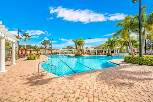 view of swimming pool with a patio and a pergola