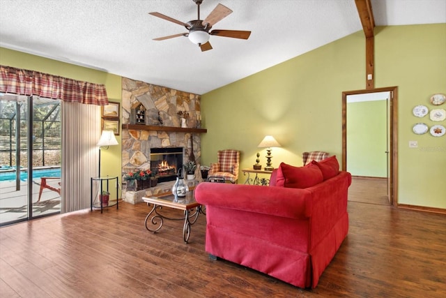 living room featuring a textured ceiling, a stone fireplace, vaulted ceiling with beams, dark hardwood / wood-style floors, and ceiling fan