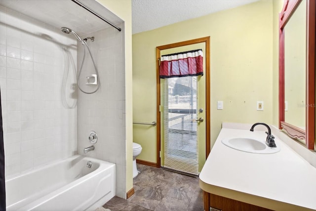 full bathroom with vanity, toilet, a textured ceiling, and shower / washtub combination